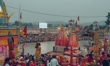 A bustling scene at Haridwar with devotees by the Ganges, showcasing cultural richness and spiritual activities.